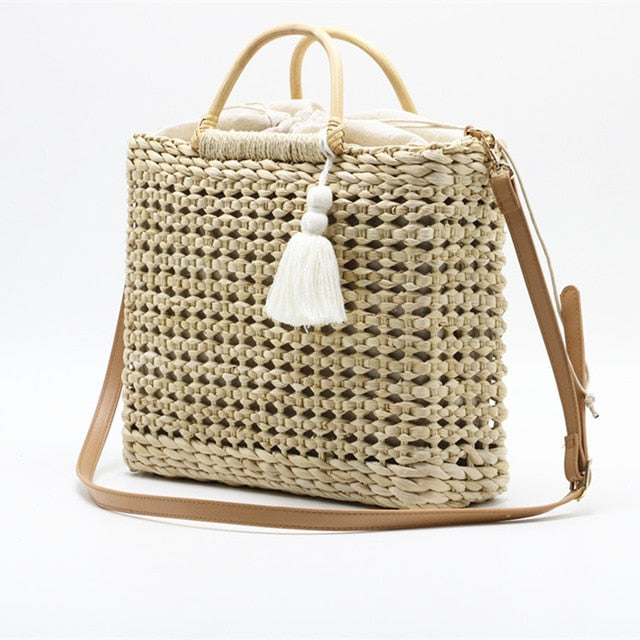 Hollow fringed woven straw bag
